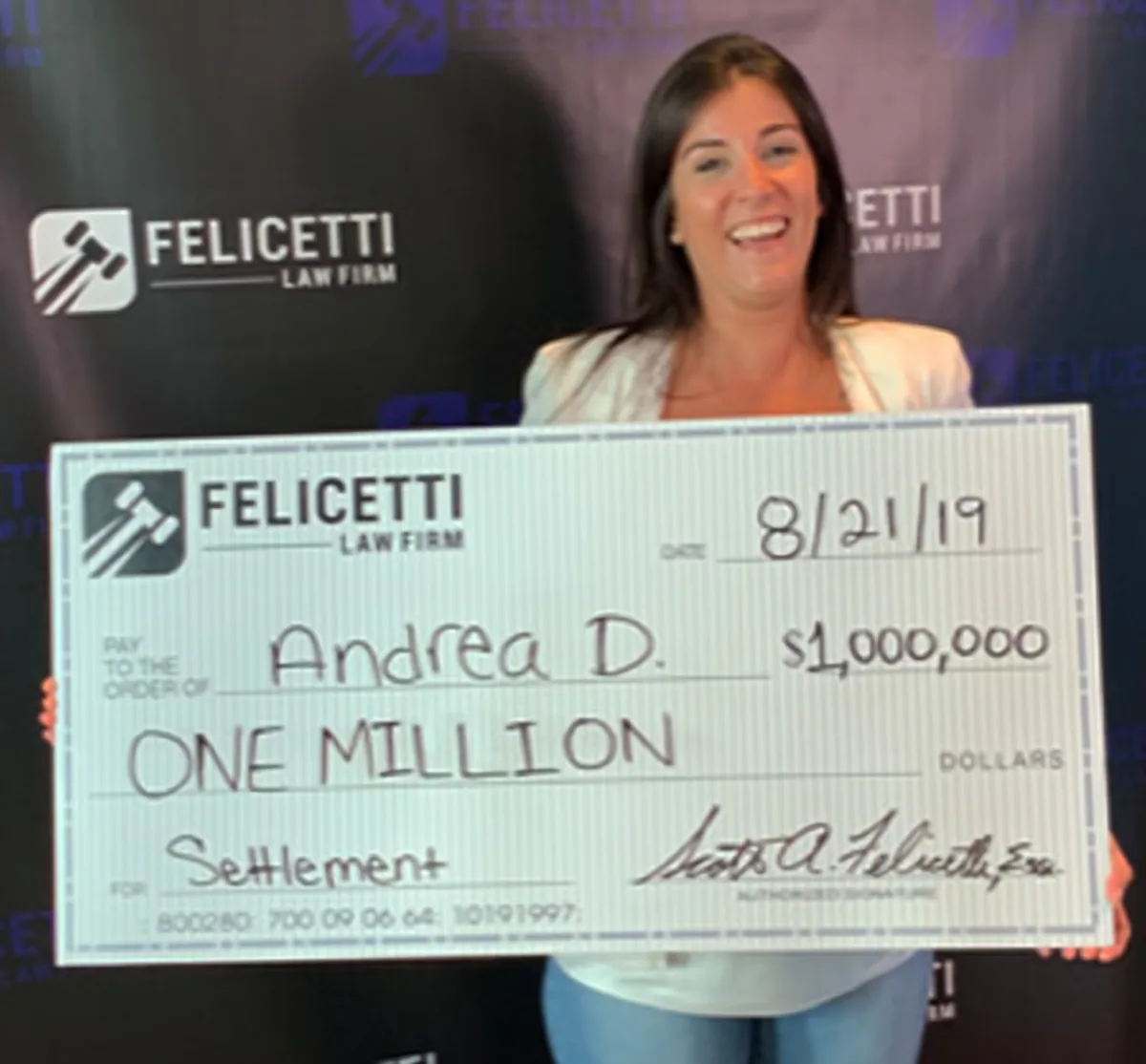 Felicetti Law Firm client holding a $1,000,000 settlement check
